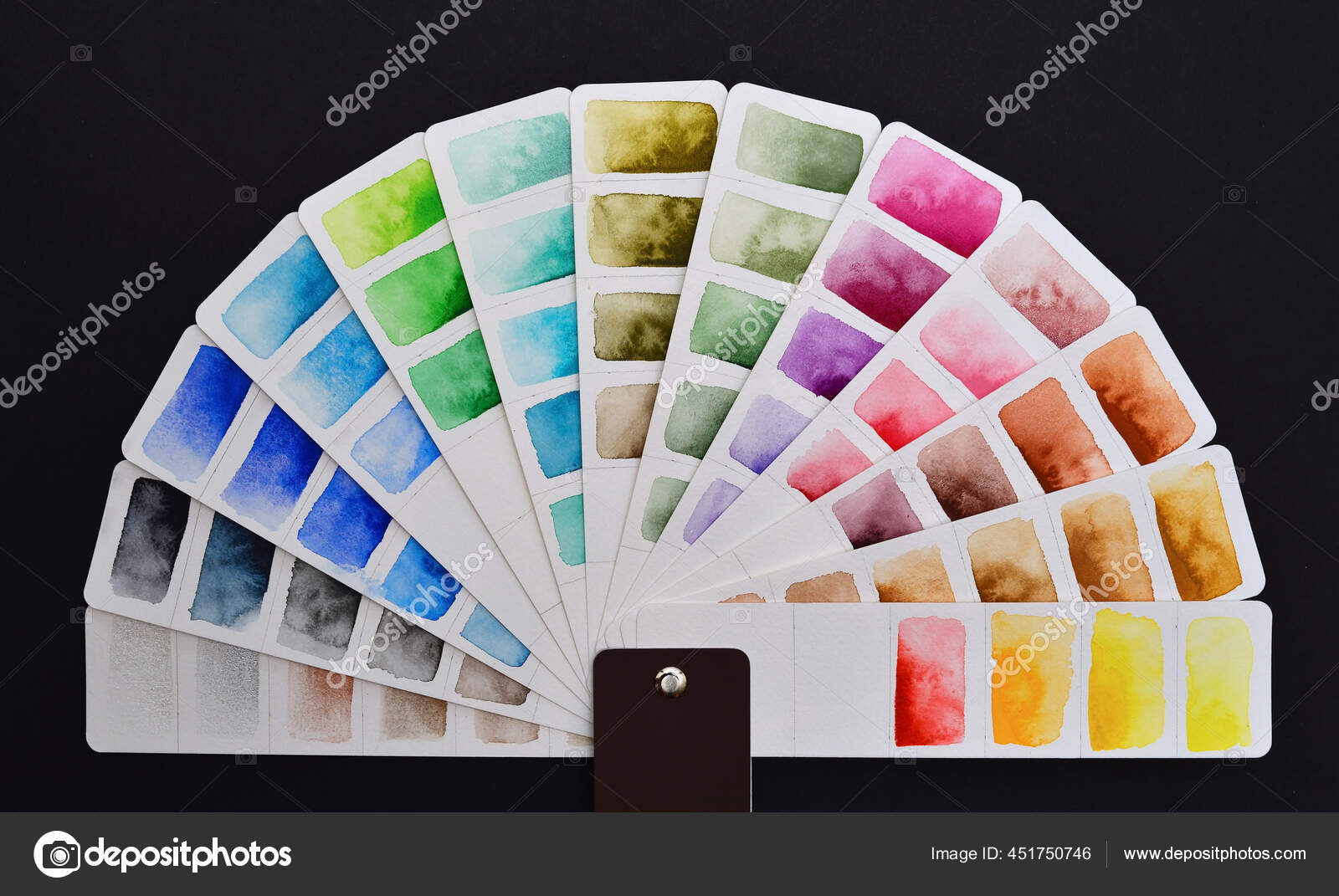 Watercolor color palette on white paper, fanned out in a semicircle, lies  on a black background. Stock Photo by ©DeriyA 451750746