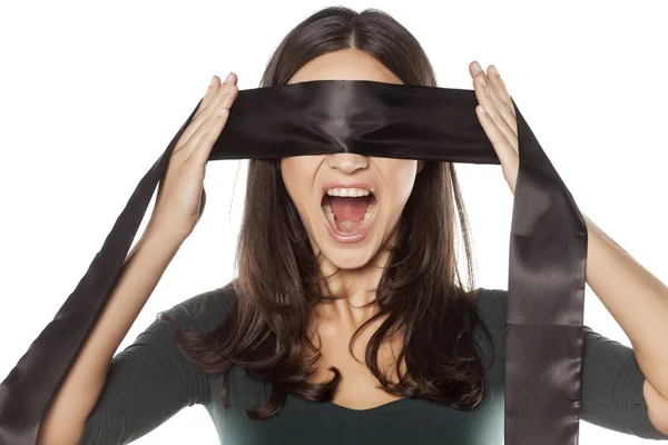 Woman blindfolding herself — Stock Photo, Image