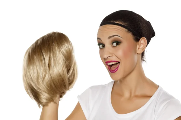 Woman holding a wig — Stock Photo, Image