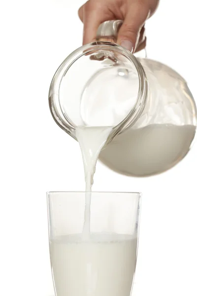 Milch in ein Glas gießen — Stockfoto