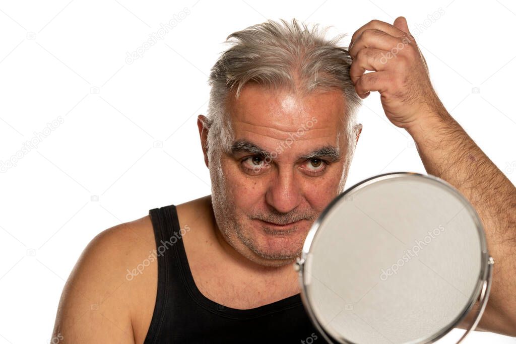 concerned middle aged man with short gray hair on white background