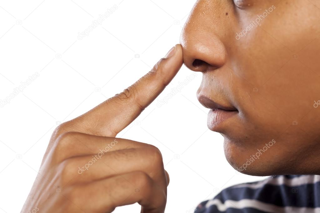 Man pressing his nose