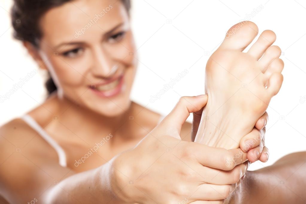 Woman massaging her feet