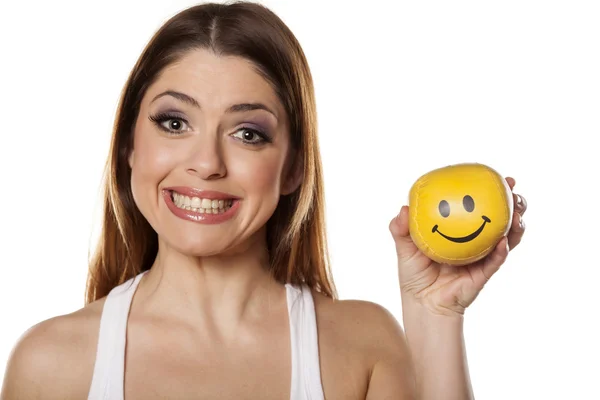 Woman holds smiley ball — Stock Photo, Image