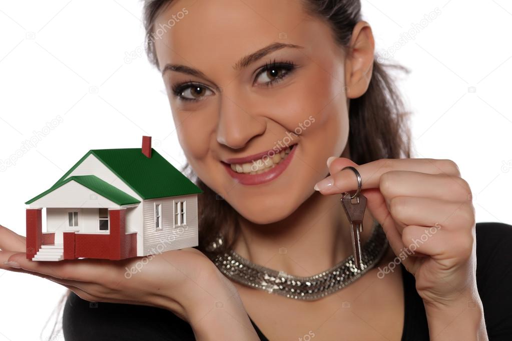 Miniature house on a hand