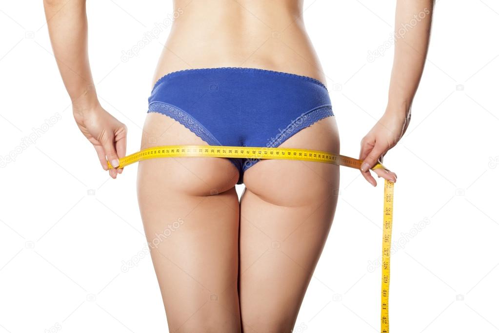woman measuring her butt