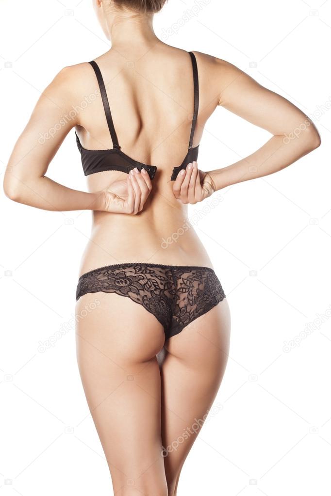 woman buttoning her bra