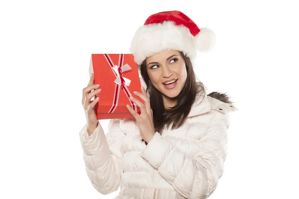 Woman with Santa Claus hat and a gift Stock Image