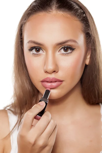 Girl applying lipstick — Stock Photo, Image