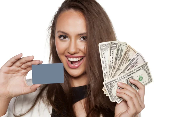 Woman holding credit card and cash — Stock Photo, Image