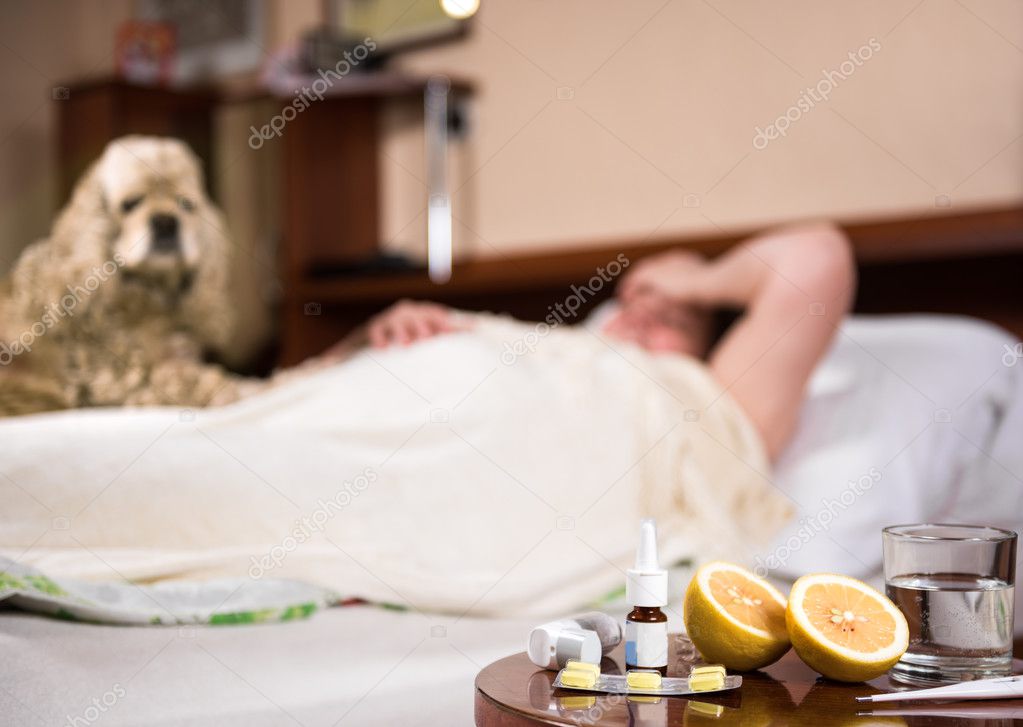 Sick woman lying at bed