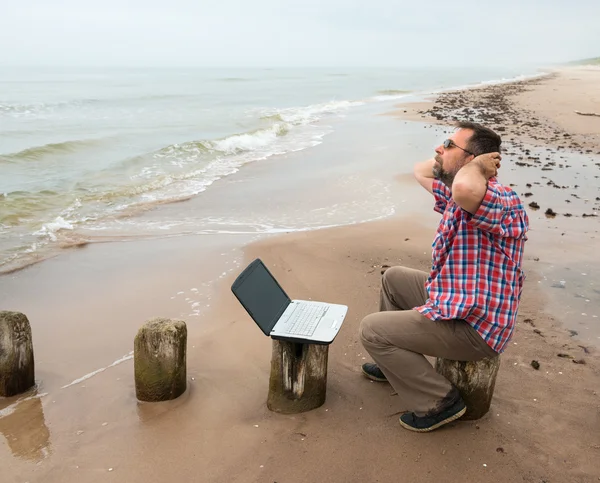 Homme assis avec ordinateur portable — Photo