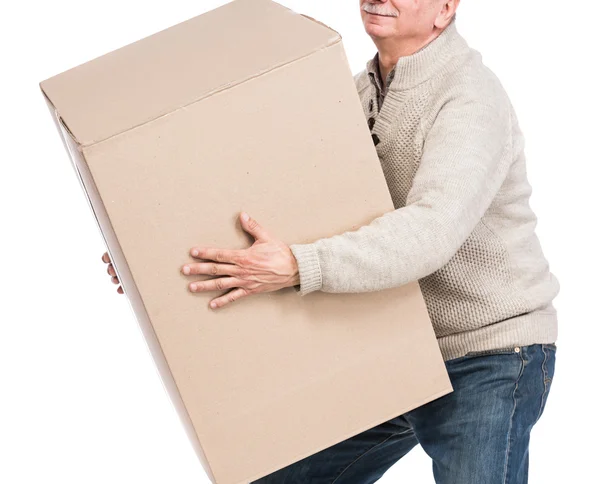 Senior man carries a heavy box — Stock Photo, Image