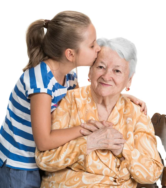 Granddaughter kissing her old grandmother — Stock Photo, Image