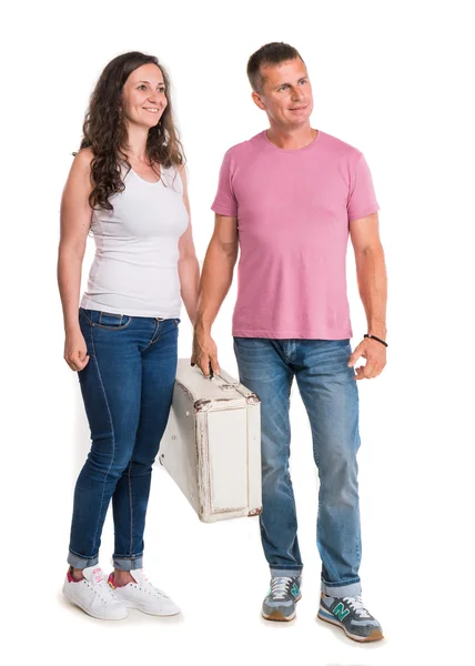 Smiling happy couple holding white suitcase — Stock Photo, Image