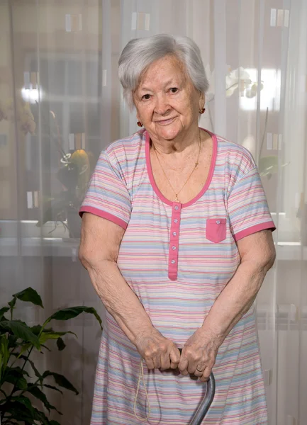 Vecchia donna in piedi con un bastone — Foto Stock