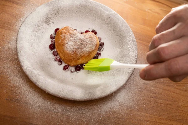 Homemade food concept. Heart-shaped donut on a wooden table