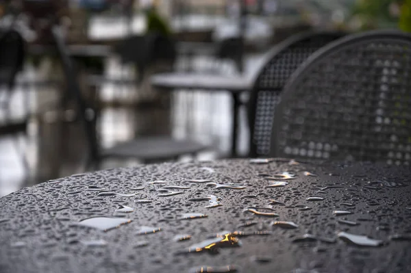 Table of a street cafe wet from the rain