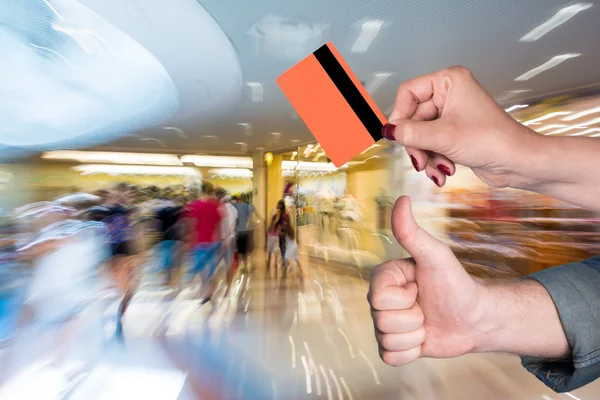 Woman holding credit card, man gesturing thumb up — Stock Photo, Image