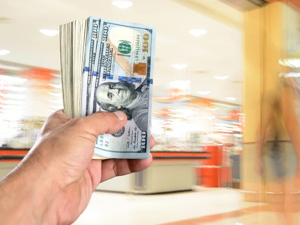 Man holding stack of dollar bills — Stock Photo, Image