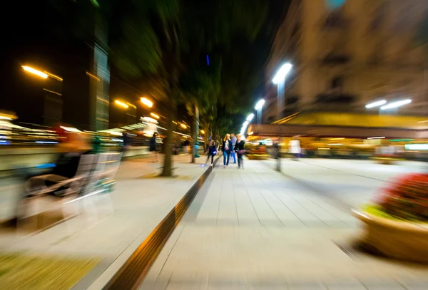 La gente siluetas en las calles de la ciudad por la noche —  Fotos de Stock