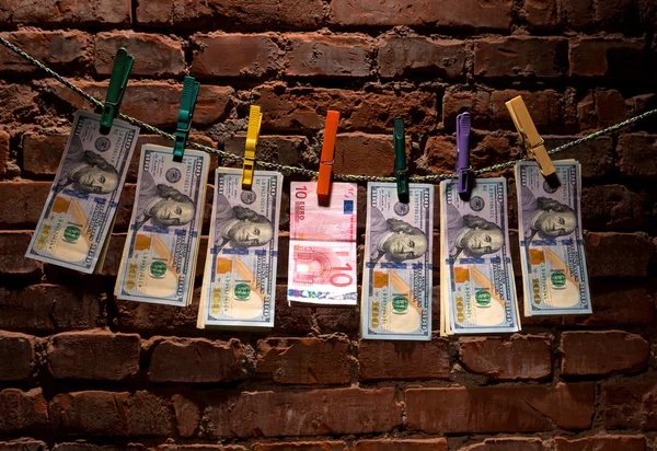 Dollar and euro bills  hanging on a rope — Stock Photo, Image