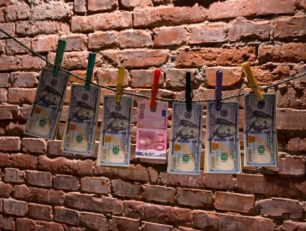 Dollar and euro bills  hanging on a rope — Stock Photo, Image