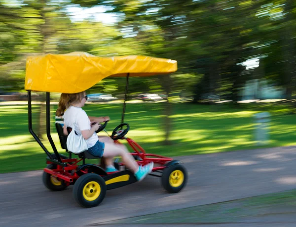 Girls racing in a pedal cart — Stock Photo, Image