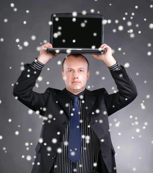 Młody biznesmen posiadania laptopa na głowie — Zdjęcie stockowe