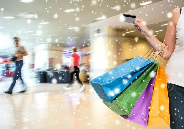 Mujer con tarjeta de crédito y bolsas de compras — Foto de Stock