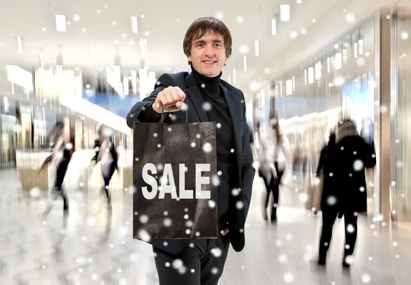 Smiling man n with shopping bag — Stock Photo, Image