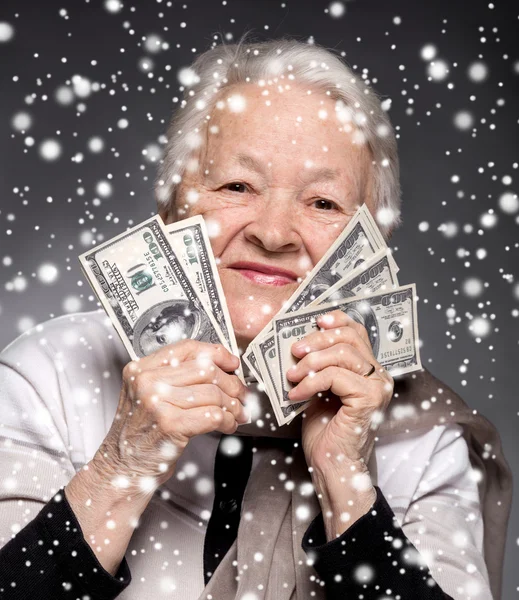 Old woman holding money in hands — Stock Photo, Image