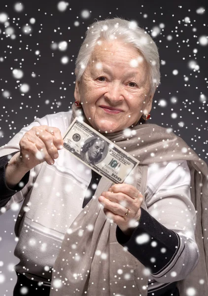 Old woman holding money in hands — Stock Photo, Image