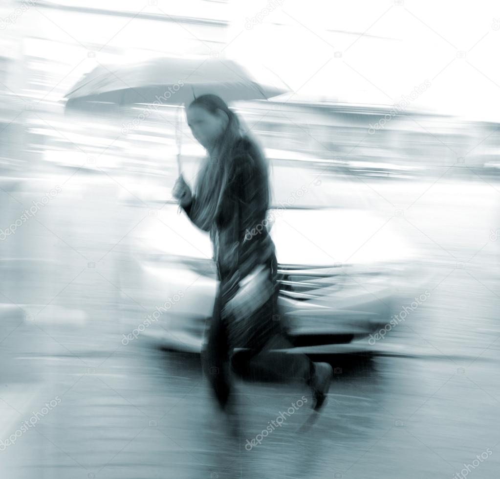 Woman walking down the street in a rainy day