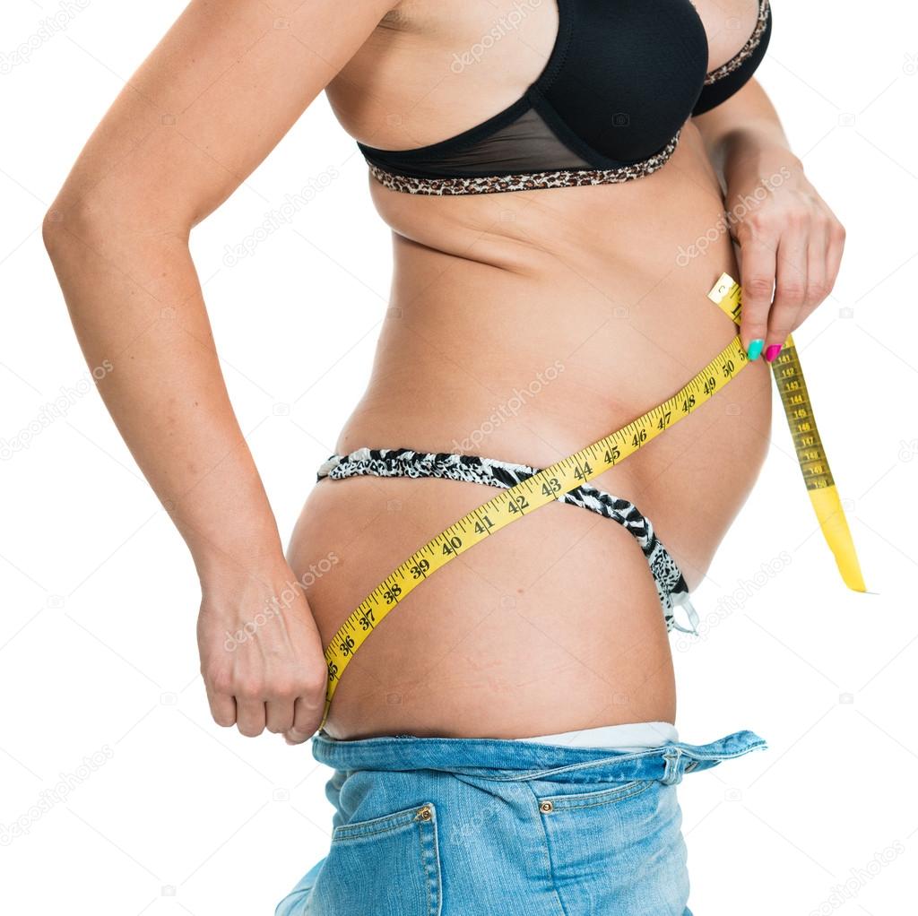 Overweight woman measuring her body