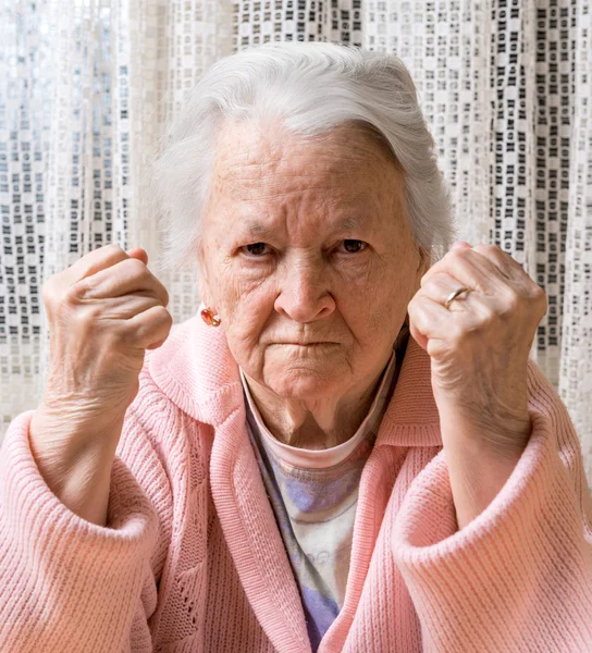 Portrait of  old woman in angry gesture — Stock Photo, Image