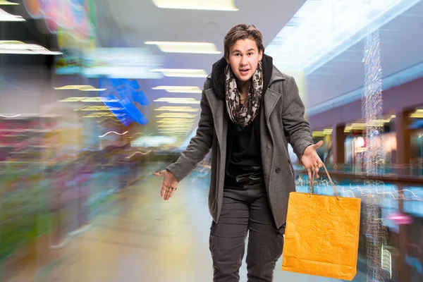 Smiling man with shopping bags — Stock Photo, Image