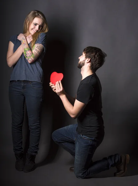 Happy couple with red heart — Stock Photo, Image