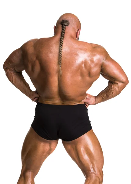 Спортсмен культурист демонструє м'язи спини і рук Ліцензійні Стокові Зображення