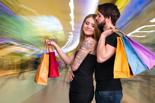 Feliz pareja con bolsas de compras —  Fotos de Stock