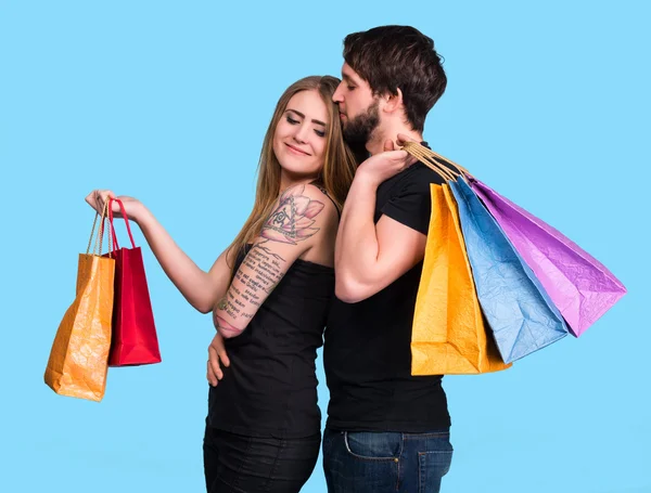 Feliz pareja con bolsas de compras —  Fotos de Stock