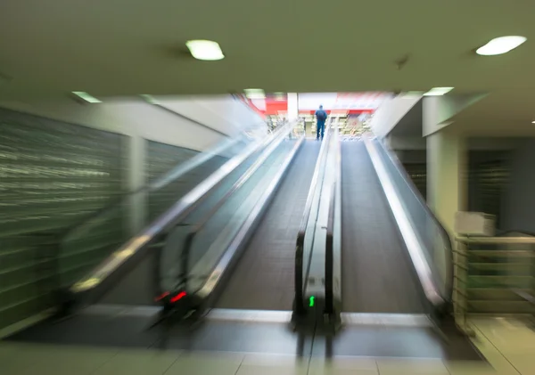 Man on moving staircase — Stock Photo, Image