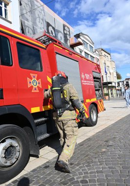 UZHOROD, UKRAINE - 30 EYLÜL 2025: İtfaiyeci ekipmanları şehir merkezindeki acil durum sırasında itfaiye aracına yaklaşıyor
