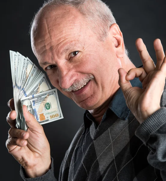 Happy elderly man showing dollars — Stock Photo, Image