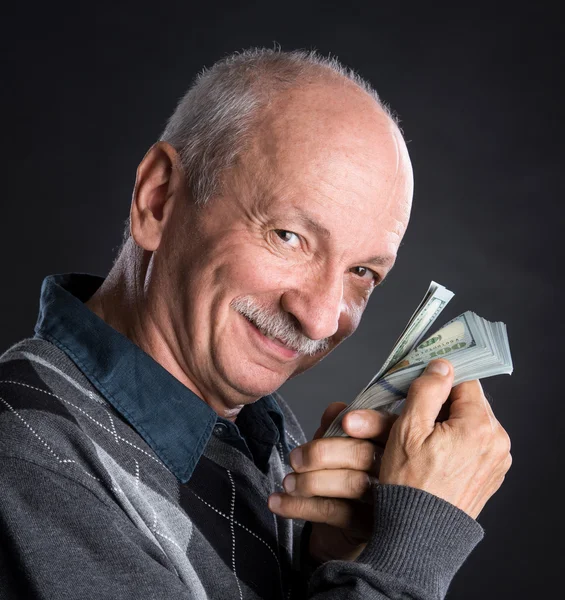 Happy elderly man showing dollars — Stock Photo, Image