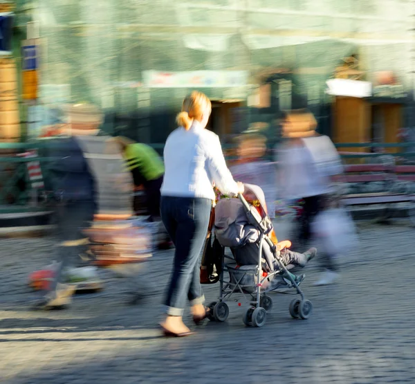Mother with small child in the stroller — Stock Photo, Image