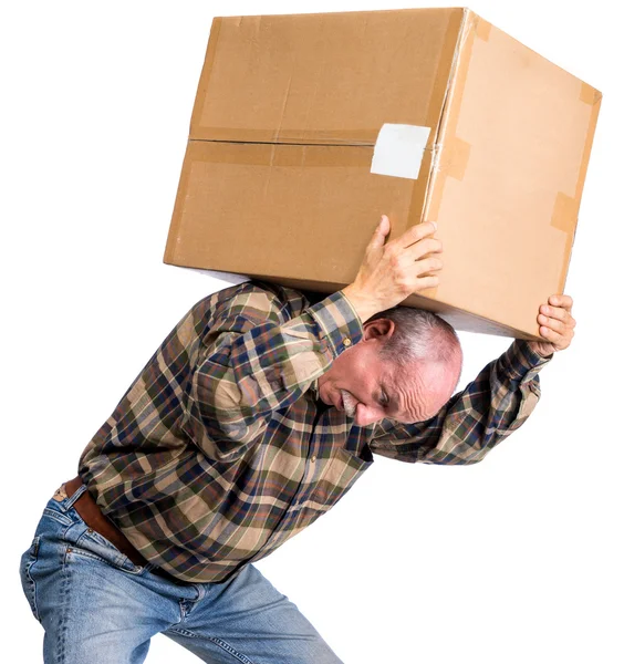 Senior man carries a heavy box — Stock Photo, Image