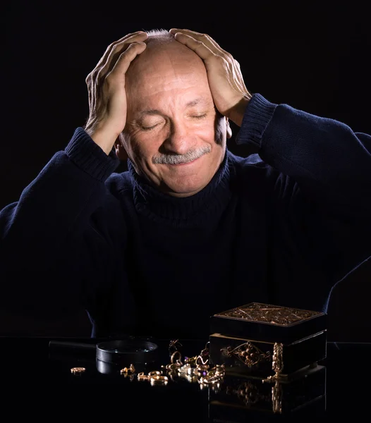 Senior jeweler  looking at jewelry — Stock Photo, Image