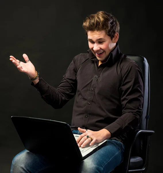 Junger schöner Mann arbeitet mit Laptop — Stockfoto