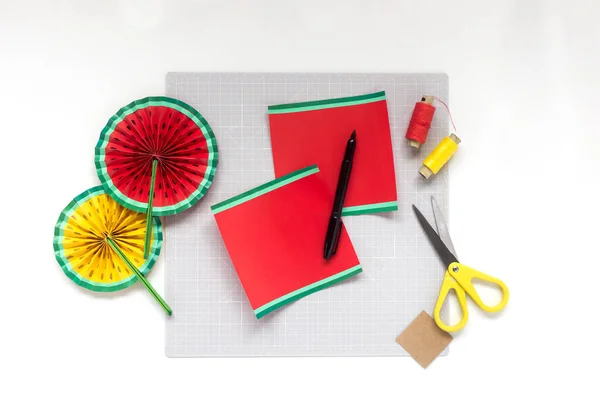 DIY instruction. Step by step tutorial. Making decor for summer birthday party - red and yellow watermelon fan. Craft tools and supplies. Step 4 — Stock Photo, Image